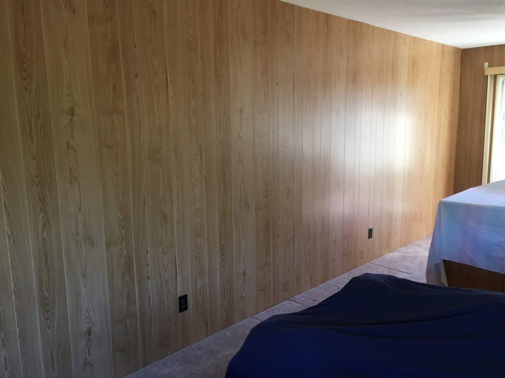 Living room wall unpainted 1970's wood paneling