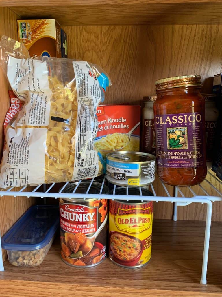 Organize RV pantry by using a wire rack shelf to provide multiple spots to place food. Just one of the good RV pantry storage ideas.