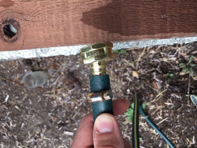 How to fix a garden hose - inserting the barbed end into the cleanly cut hose