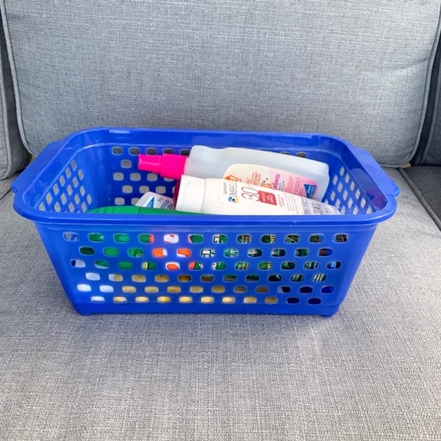 A plastic basket is a handy spot to keep the camping essentials of sunscreen and bug repellent spray