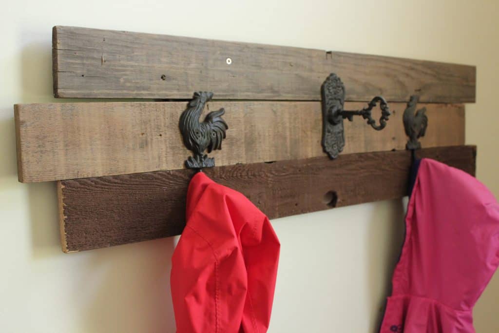 DIY Farmhouse Coat Rack that I built using old weathered boards and some farmhouse coat hooks.