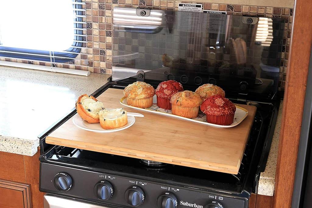 RV kitchen organization idea - maximize space in your rv kitchen by getting a stove-top cutting board. This one is made from bamboo