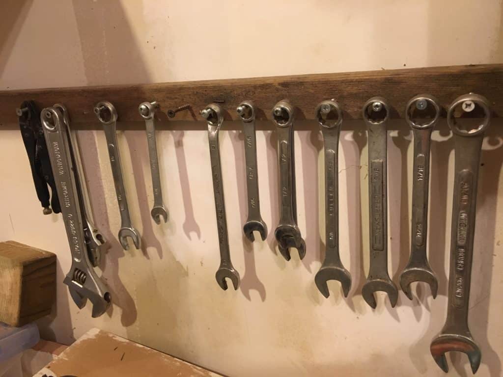 DIY wrench storage idea - screw some screws into a piece of wood and hang the wrenches from the screw.