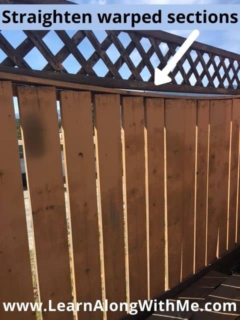 Straighten and fix warped sections of a wooden fence to improve the look of the fence