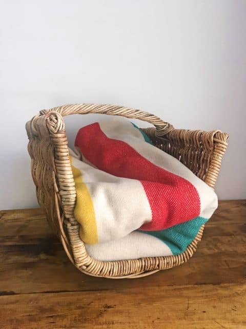 Wicker basket to store blankets. THis is a basket from the Etsy seller ToutePetiteTreasures