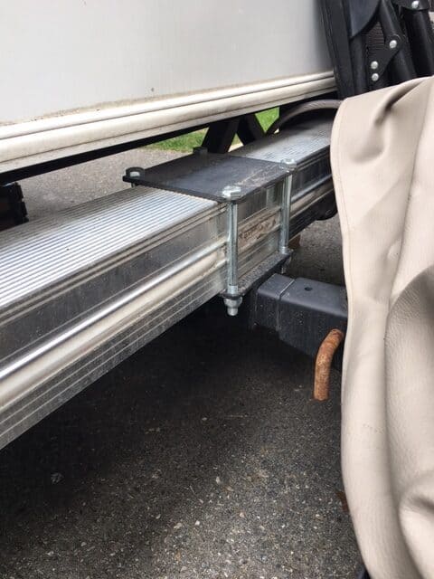 RV bumper cargo carrier inserted inside a bumper-mounted hitch receiver