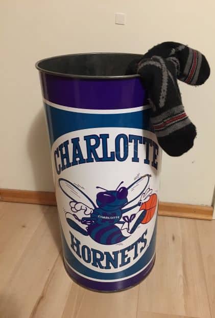Charlotte Hornets metal tin being used as a sock storage bin.