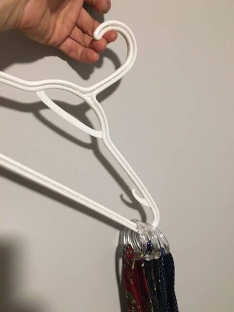 Unfortunately the ties slide to one side of the hanger when you're using plastic shower rings as tie storage hoops