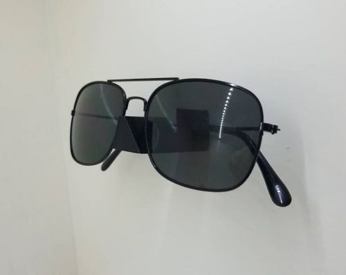 sunglasses storage idea - these are plastic, wall-mounted sunglasses holders that will hold a single pair of sunglasses.
