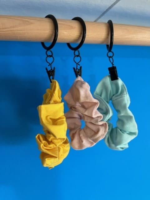 You can hang scrunchies by clipping curtain clips to them