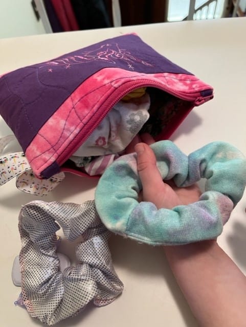 you can use an old makeup bag or other zippered bag (like a pencil case) to store your scrunchies