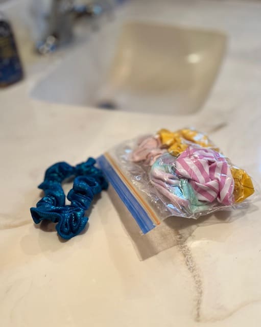 A simple way to store scrunchies is inside a plastic ziploc bag.