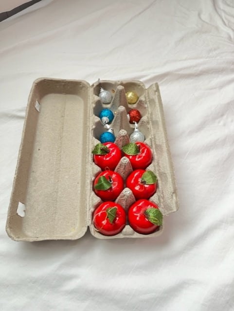 You can use old egg cartons to store Christmas ornaments. The carton will help protect your fragile decorations.