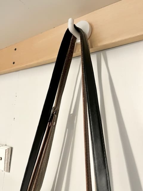 you can hang purses from simple wall hooks mounted to your bedroom wall or inside your closet.