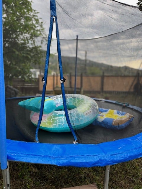 Store pool floats inside your trampoline's safety net enclosure if you have one